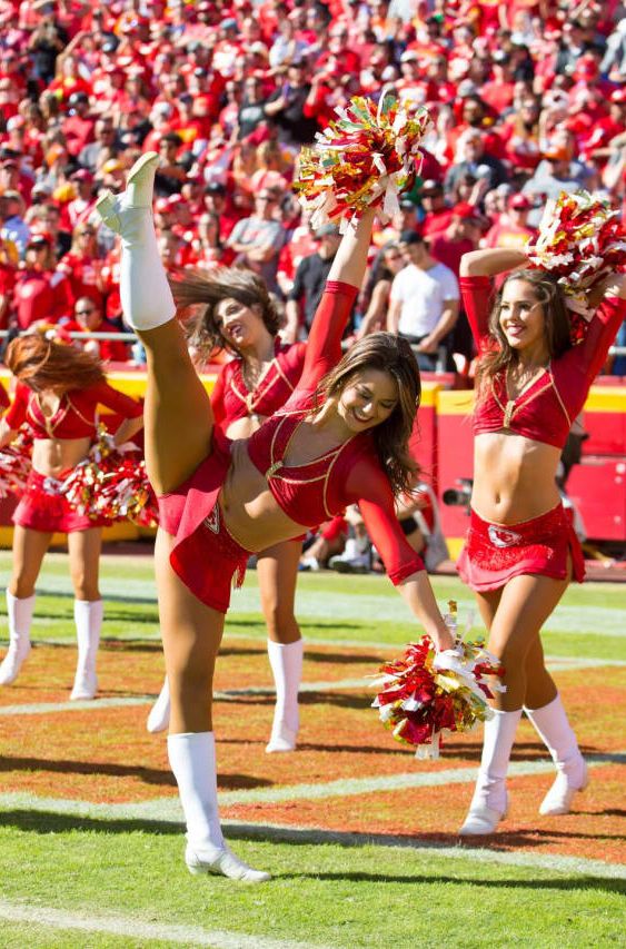 the cheerleaders are performing on the field for their team's football game