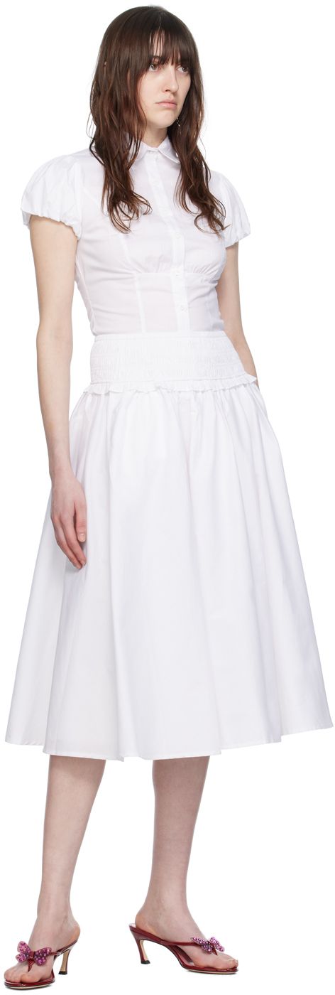 Stretch cotton poplin skirt. Gathering throughout. · Ruffles at shirred elasticized waistband · Two-pocket styling · Fully lined Supplier color: White Spring Tiered Skirt With Gathered Waist, Chic Midi Skirt With Gathered Waist, Cotton Ruched Skirted Bottoms, Fitted Ruched Cotton Skirt, Fitted Flared Skirt With Gathered Waist, Ruched Skirt For Workwear And Summer, Ruched Skirt For Workwear In Summer, Flowy Ruched Cotton Skirt, Summer Daywear Waist-length Skirt