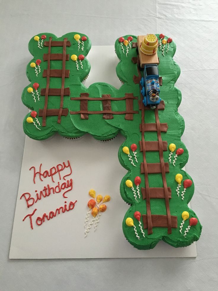 a birthday cake shaped like a train track