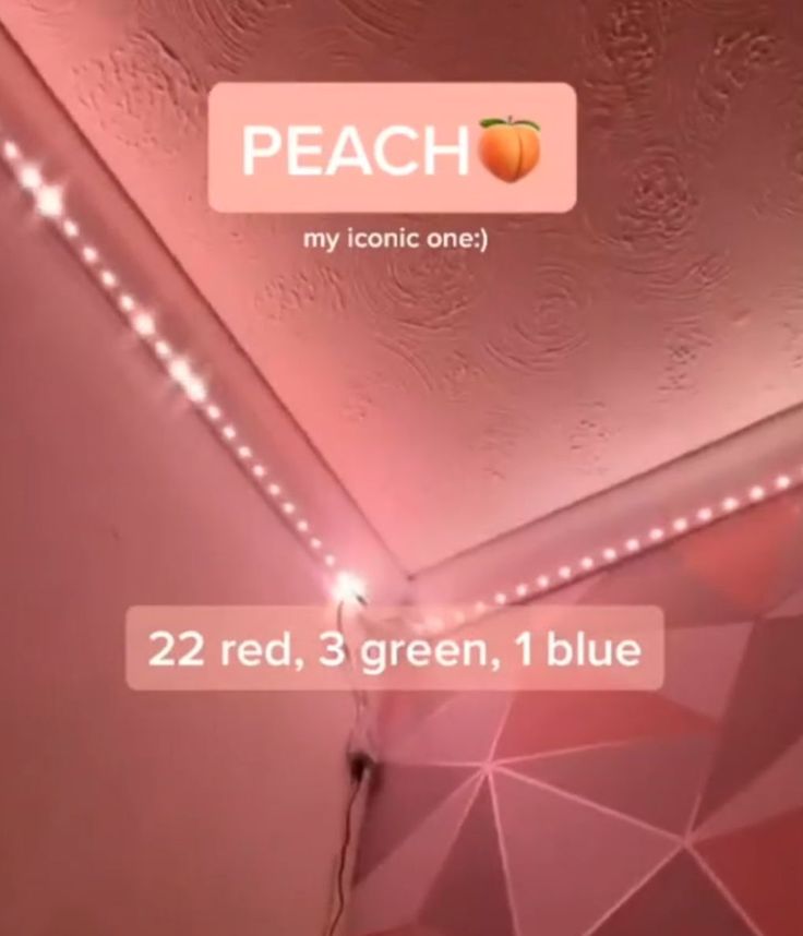 the ceiling is covered in pink lights and has an orange on it's side