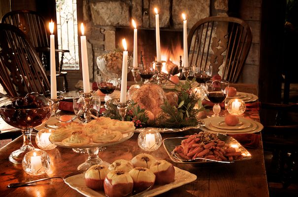 a dinner table is set with food and candles