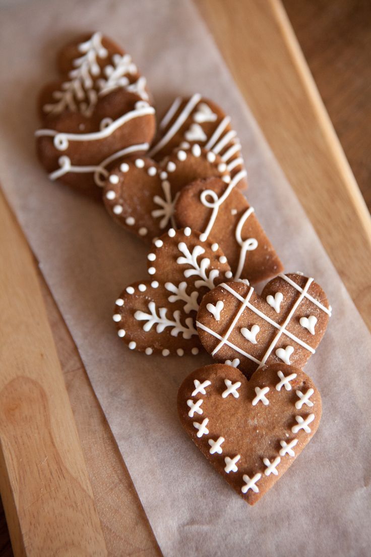 three heart shaped gingerbreads sitting on top of a piece of paper