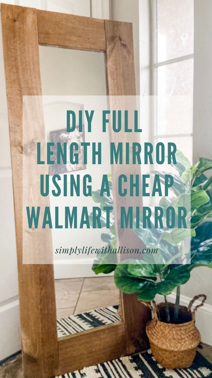 a wooden mirror sitting on top of a rug next to a potted plant and a window