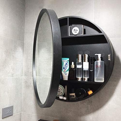 a round mirror mounted to the side of a wall