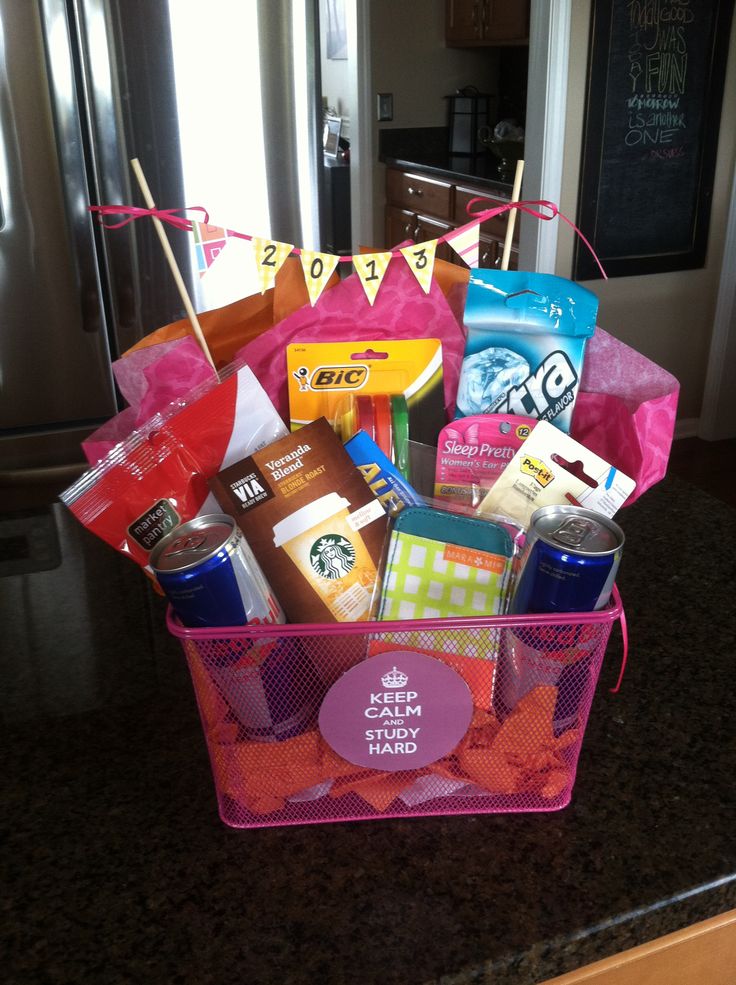 a pink basket filled with lots of different types of items on top of a counter