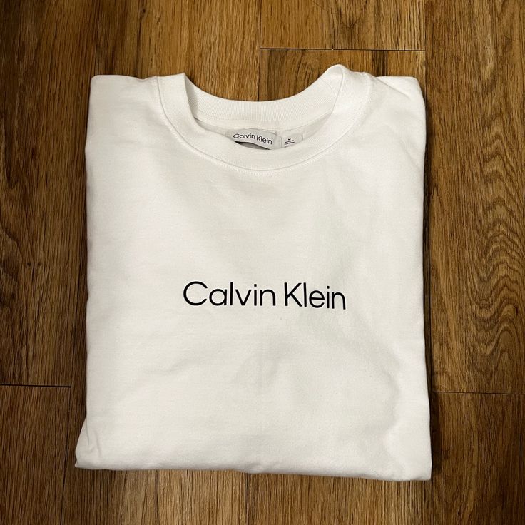 Brand New! Never Worn! Long Sleeve White T Shirt 100% Cotton Calvin Klein Brand Calvin Klein Spring Tops For Everyday Wear, Calvin Klein Cotton Crew Neck Top, Calvin Klein Relaxed Fit Cotton Shirt, Calvin Klein Crew Neck Top With Logo Print, Calvin Klein Logo Print Crew Neck Top, Calvin Klein White Relaxed Fit T-shirt, Calvin Klein Crew Neck Tops For Loungewear, Calvin Klein Cotton Tops For Loungewear, Calvin Klein Spring Everyday Tops