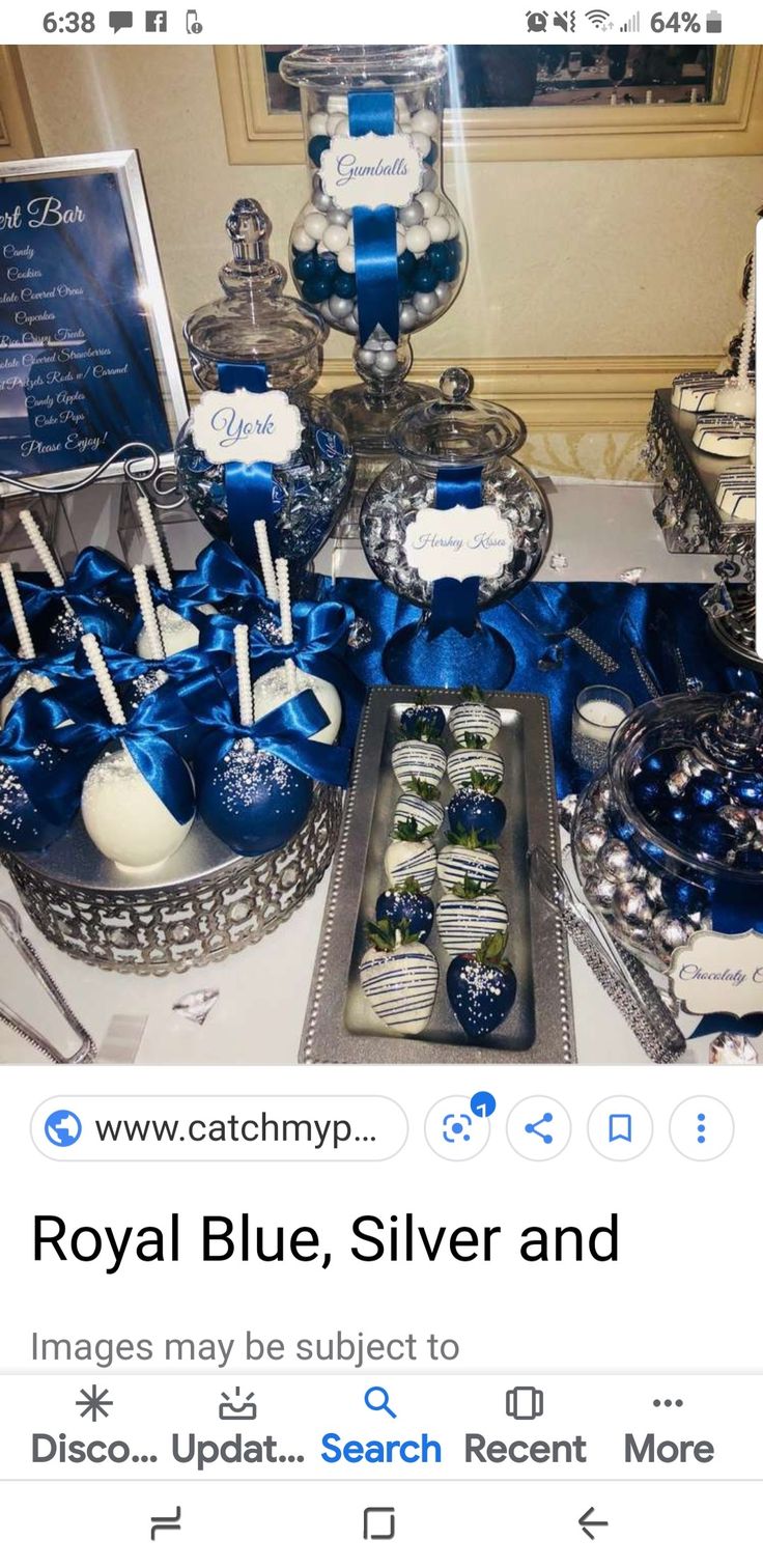 a table topped with lots of blue and white desserts