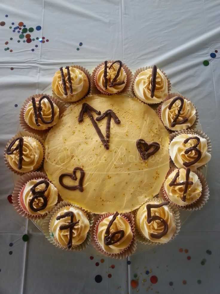 a birthday cake with cupcakes arranged in the shape of an i love you sign