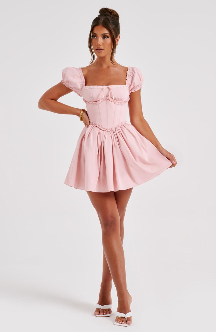 Must-have milkmaid minis are what we're wearing ALL season with sleek waves and mule heels. Penelope has dreamy puffed sleeves with a snatched waist and pretty tie detail to the bust. The look is complete with a voluminous skirt.



Colour: Blush.

Premium non stretch cotton.

Underwired bust.

Puffed sleeves.

Waist cinching.

Tie to bust.

Voluminous skirt.

Mini length.

Model is an XS and is wearing an XS

 Size: XS, S, M, L, XL, XXL Sleek Waves, Snatched Waist, Lace Mini Skirt, Dress With Corset, Mule Heels, Street Dress, Tube Top Dress, Maxi Dress Sale, Sparkle Dress