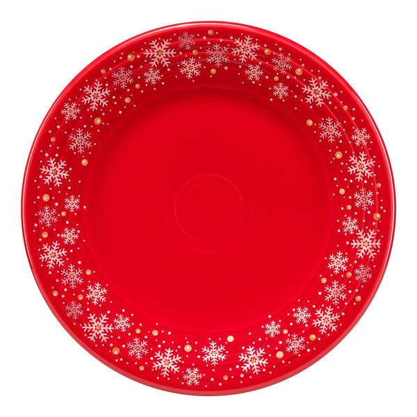 a red plate with white snowflakes on it