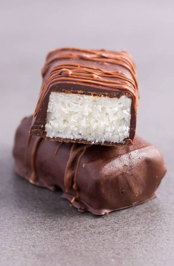 two pieces of chocolate and marshmallow on top of each other