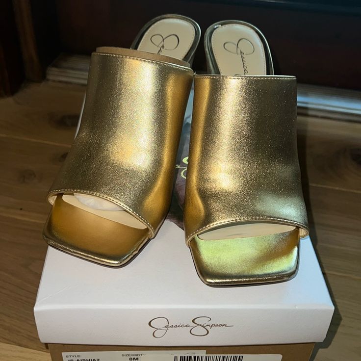 Jessica Simpson Gold Metallic Italia Nappa P Aishia 8.5 Medium Width Brand New In Box. 3 1/2inch Heel Gold Open Toe Mules With Stacked Heel, Gold Mules With Stacked Heel For Spring, Gold Synthetic Block Heel Shoes, Gold Mules With Stacked Heel, Gold Closed Toe Wedge Sandals For Formal Occasions, Gold Synthetic Sandals With 4-inch Heel, Elegant Gold Block Heel Mules, Formal Gold Mules With Block Heel, Gold Block Heel Wedge Sandals For Evening