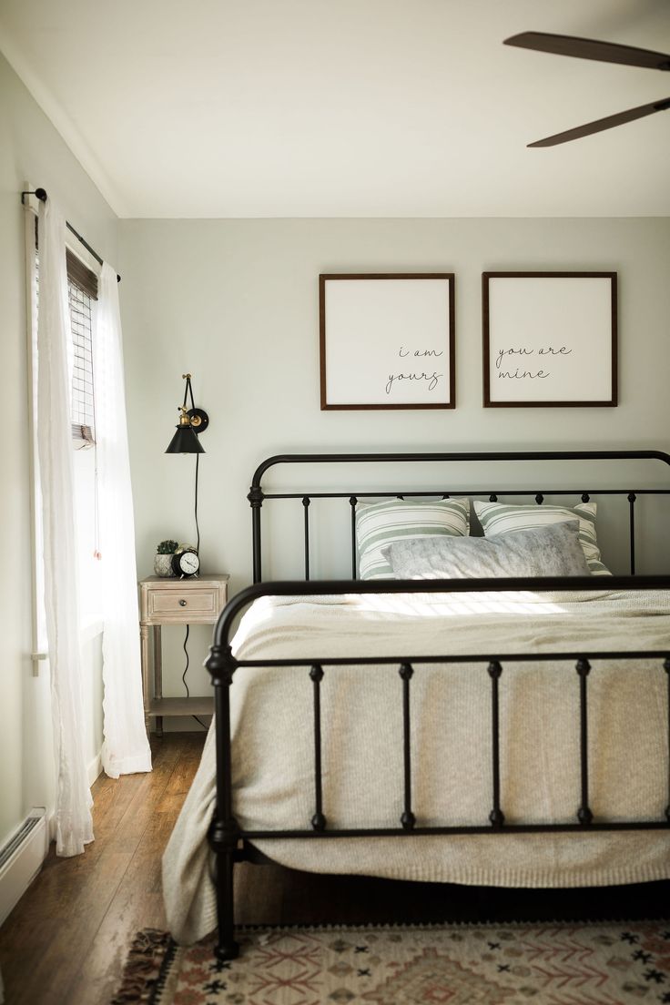 a bedroom with two framed pictures above the bed