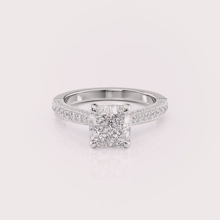 Make a lasting impression with this magnificent 2 carat cushion cut lab diamond engagement ring. The captivating center stone boasts a romantic square shape with soft, rounded corners, exuding timeless elegance. A dazzling array of round cut diamonds flanks the center stone, adding a touch of brilliance and fire from every angle. Crafted in sleek 14k white gold, this ring is a symbol of everlasting love and commitment, perfect for the woman who appreciates a classic design with a touch of modern flair. ✤𝐂𝐞𝐧𝐭𝐞𝐫 𝐃𝐢𝐚𝐦𝐨𝐧𝐝 𝐃𝐞𝐭𝐚𝐢𝐥𝐬 Color: F Clarity: VS1 Shape: Cushion Cut Carat Weight: 2CT Approx. Type: Lab Grown Diamond(CVD/HPHT) ✤ Ring 𝐒𝐢𝐝𝐞 𝐃𝐢𝐚𝐦𝐨𝐧𝐝 𝐃𝐞𝐭𝐚𝐢𝐥𝐬 Color: F Clarity: VS1 Shape: Round cut Carat Weight: 0.40 CT Approx. Type: Lab Grown Diamonds(CVD/HPH White Square Cut Moissanite Wedding Rings, Classic Cushion Cut Ring With Pave Setting, Square Cut Moissanite Diamond White Ring, Timeless Square Cut Moissanite Diamond Ring, Diamond White Moissanite Square Cut Ring, Diamond White Square Cut Moissanite Wedding Ring, Timeless Square Cut Diamond White Wedding Rings, Lab Grown Diamond Wedding Ring With Cushion Cut, Cushion Cut Lab Grown Diamond For Wedding