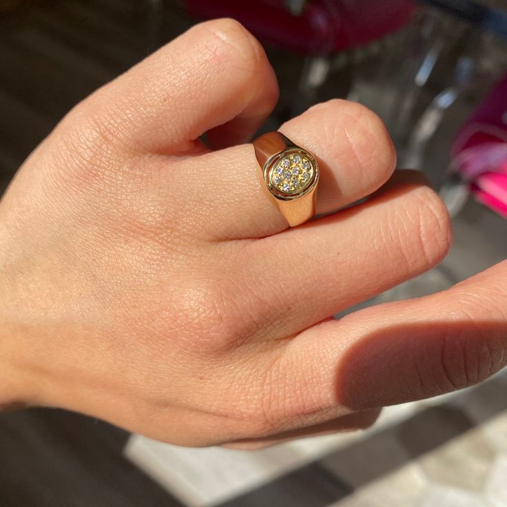 This pave-studded oval top ring is like the sparkly signet of our bold, gold dreams! She’s sweet as pie and a darling addition to your suite of jewels. We love a hefty gold look on the finger, and a touch of sparkle never hurt anybody. The cutouts on the oval top also lend some airiness to the ring that we totally love! 18kt yellow gold, size 6.5 & fully resizable.Diamonds are estimated to be H/I colors & VVS/VS1 clarities. GIA standards.Please see qualitative report for more information. Everyday Yellow Gold Diamond Signet Ring, Gold Oval Signet Ring With Pave Setting, Gold Oval Signet Ring With Diamond Accents, 14k Yellow Gold Pave Setting Signet Ring, Oval Gold Signet Ring With Diamond Accents, Classic 14k Gold Signet Ring With Pave Setting, Yellow Gold Oval Dome Ring With Pave Setting, 14k Yellow Gold Signet Ring With Pave Setting, Gold Round Signet Ring With Single Cut Diamonds