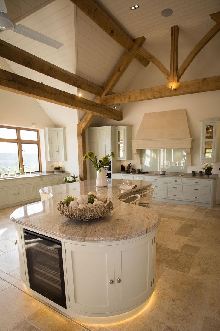 a large kitchen with an island in the middle and two ovens on each side