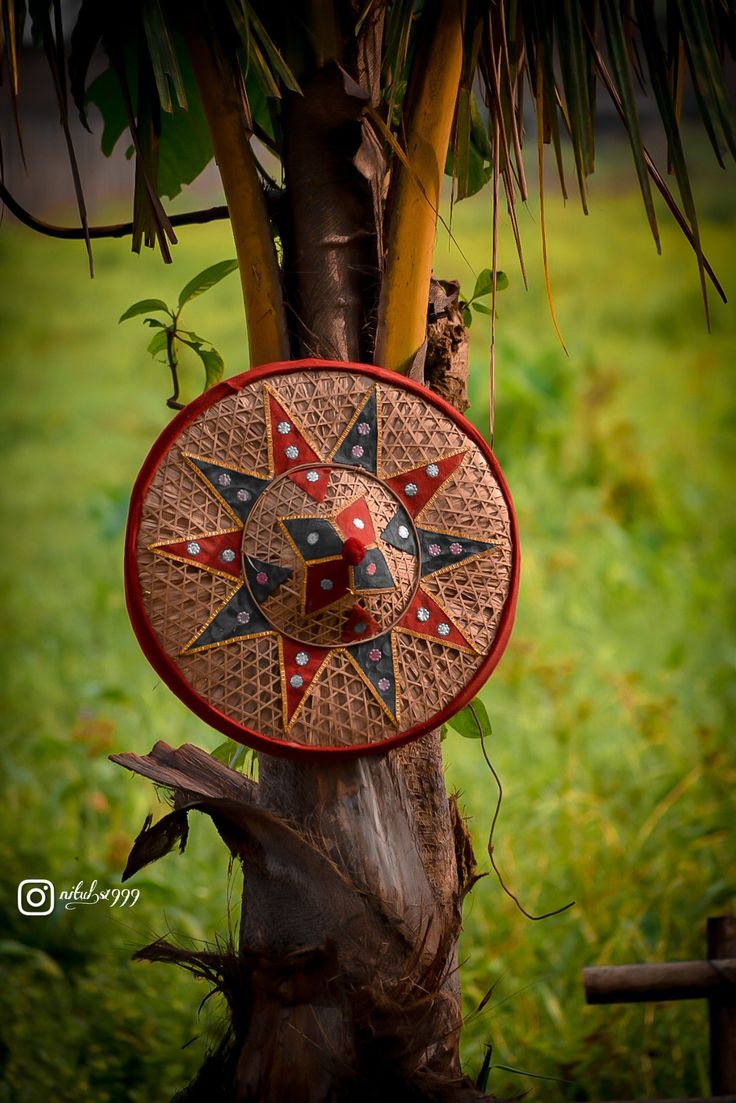 a red and black decorative clock on a tree