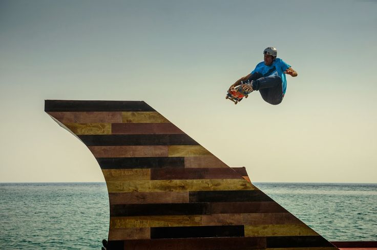 a man flying through the air while riding a skateboard on top of a ramp