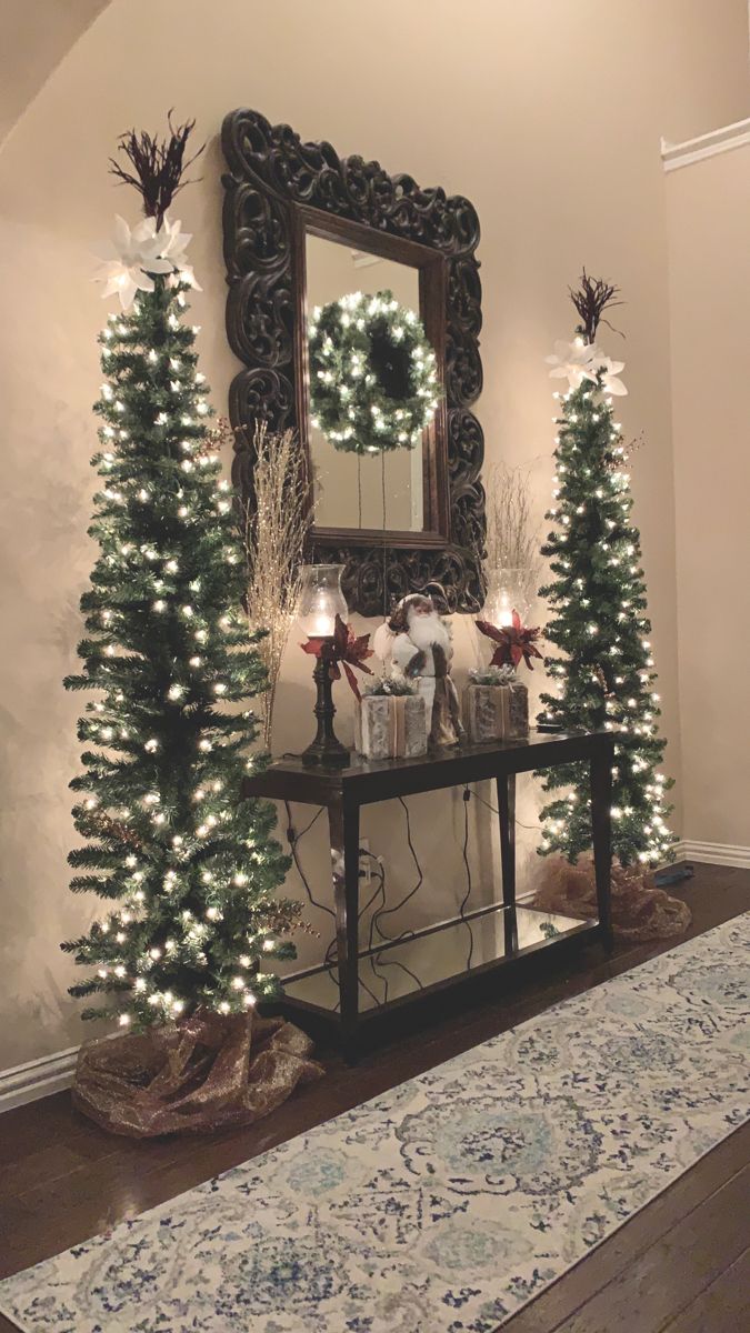 christmas decorations and lights in front of a mirror on a table with a blue rug