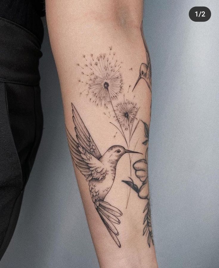 a woman's arm with a bird and dandelion tattoo design on it