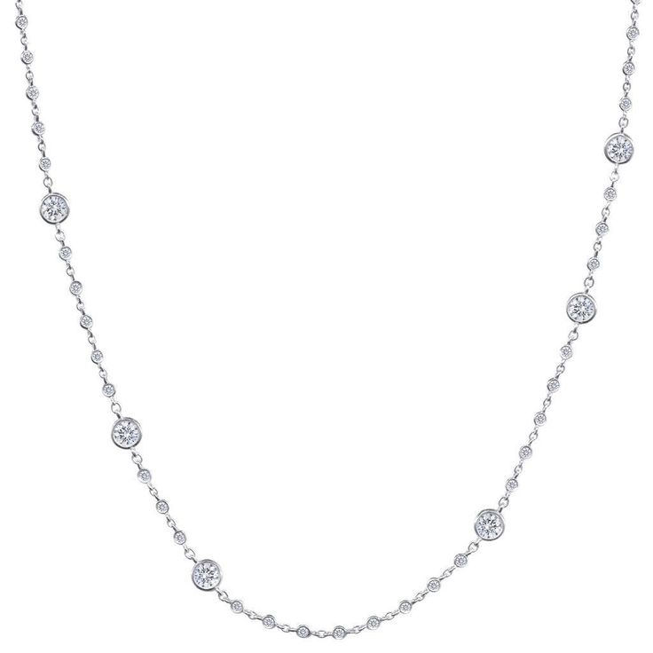 The love is in the details with this diamond by the yard necklace. Featuring an intricately detailed chain made of micro bezel diamonds that shines separating staggering larger bezel set diamonds, this 18k white gold necklace dances on your skin. So much glimmer packed into one dazzling diamond necklace that is ideal for everyday outfits! 18k White Gold 70 Round Diamonds 2.24ctw Diamonds Bezel Set Diamonds 16" Length Lobster Clasp Diamond Backdrop Necklace With Diamond Accents, Fine Jewelry Diamond Backdrop Necklace With Accents, Elegant Silver Station Necklace With Single Cut Diamonds, Silver Diamond Station Necklace With Delicate Chain, Luxury Diamond Station Necklace With Bezel Setting, Dazzling Diamond-white Diamond Necklace With Bezel Setting, Diamond Bezel Setting White Gold Station Necklace, White Gold Diamond Station Necklace With Bezel Setting, Fine Jewelry Diamond Station Necklace In Silver