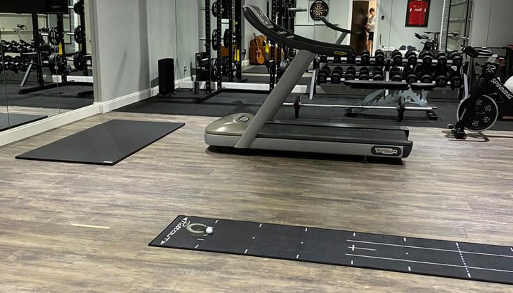 a gym with treadmills and exercise mats