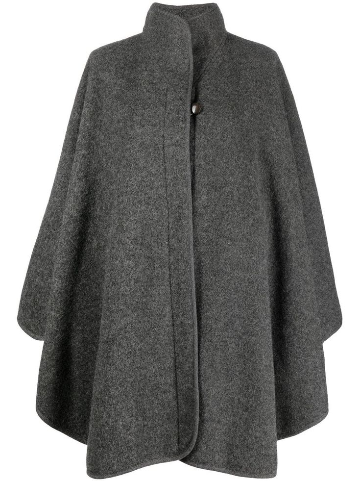 circa 1970s grey wool stand-up collar concealed front fastening bell sleeves knee-length straight hem Purchasing this item continues its narrative and reduces the environmental impact by avoiding the use of new resources needed to make the product from scratch, such as water, materials and electricity, and avoiding additional manufacturing impact. Learn more about what makes a product Conscious on our Conscious Criteria page Coat Cape, Wool Cape Coat, Cape Fashion, Winter Mode Outfits, Poncho Coat, Kaftan Designs, Womens Clothing Patterns, Stylish Blouse Design, Couture Tops