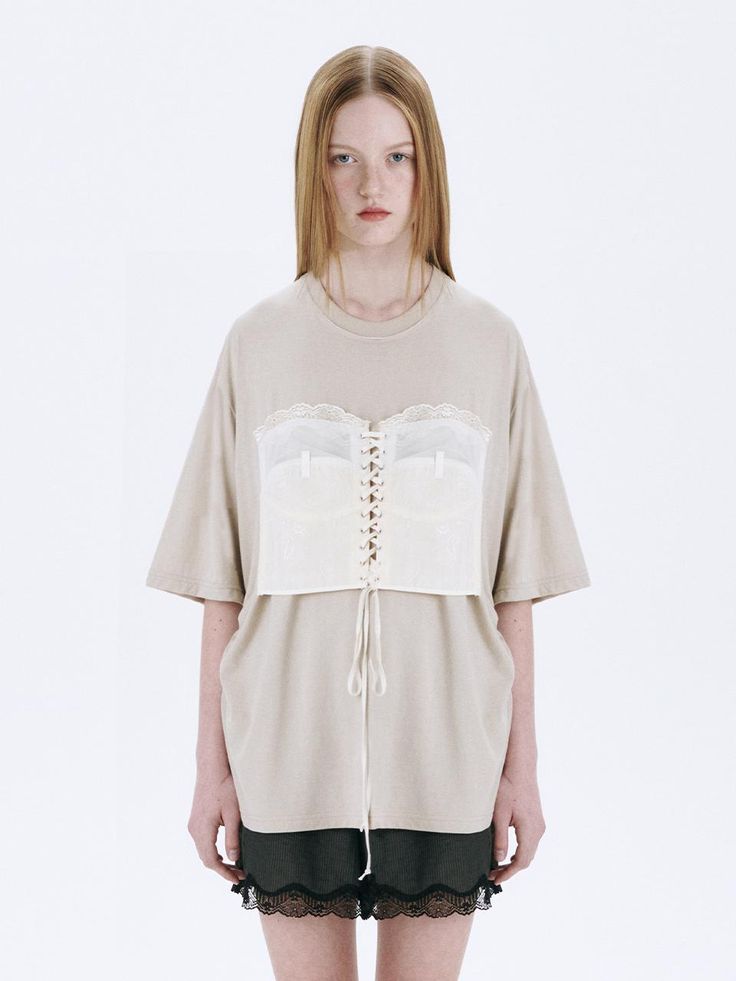 This is a trendy and casual top by MARGESHERWOOD that is made out of high quality and sturdy material. With distinctive mood of the design and comfortable wear, you can style it for your casual daily outfit.- Relaxed oversized silhouette- Corset detail with eyelets and strings- Cotton 100% pigment fabric Oversized Chic T-shirt For Fall, Spring Oversized Beige T-shirt, Oversized Cotton Knit Top With Short Sleeves, Oversized Cotton Short Sleeve Knit Top, Oversized Short Sleeve Knit Top For Fall, Oversized Knit Top With Short Sleeves For Fall, Chic Cream Tops For Layering, Beige Relaxed Fit Blouse For Layering, Chic Neutral Tops For Layering