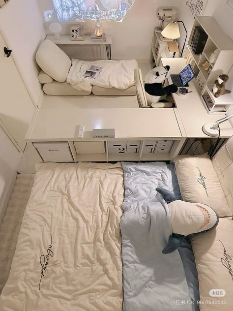 a small room with a bed, desk and computer on top of the dressers