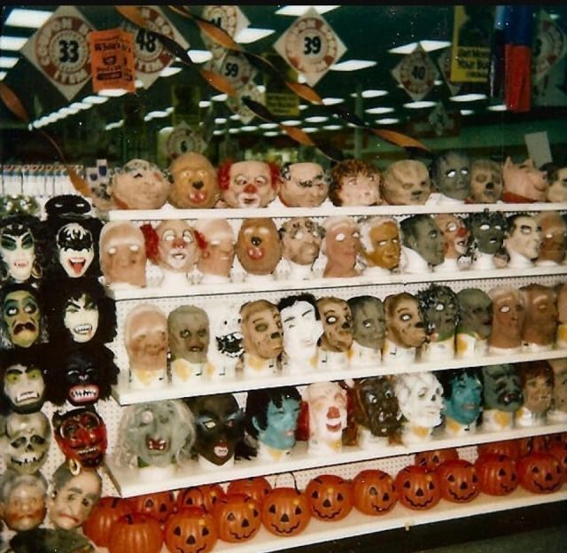 there are many halloween masks on the shelves