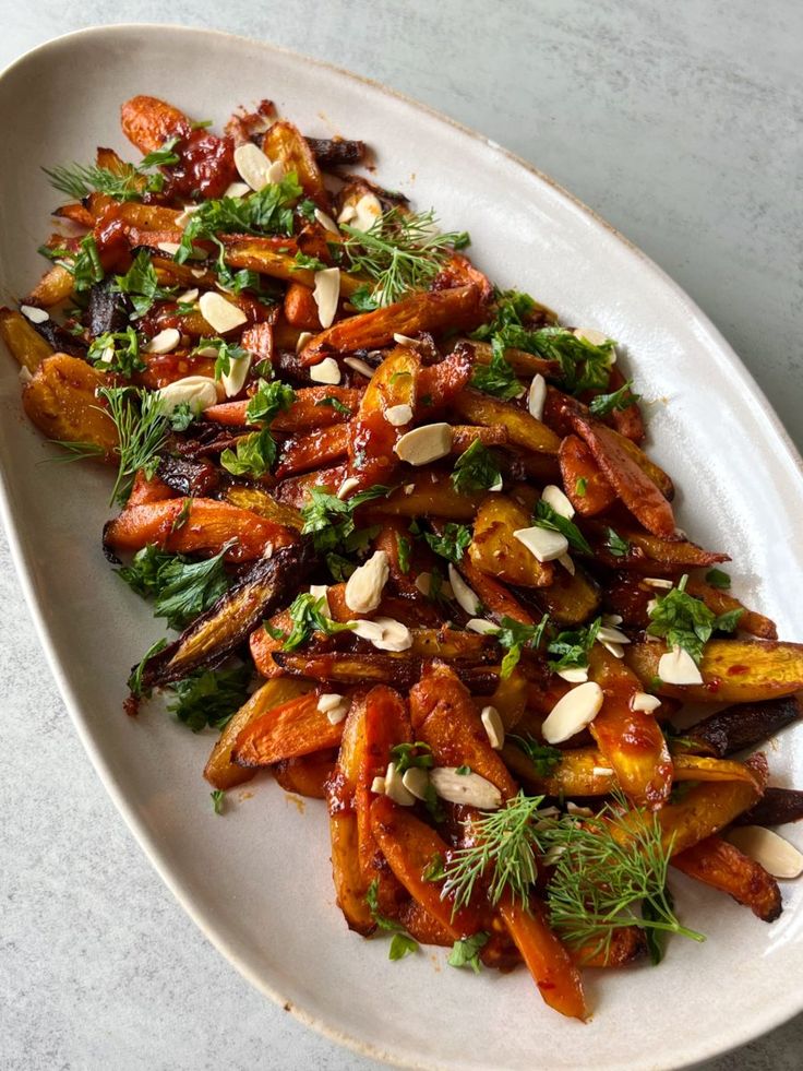 a white plate topped with carrots and nuts