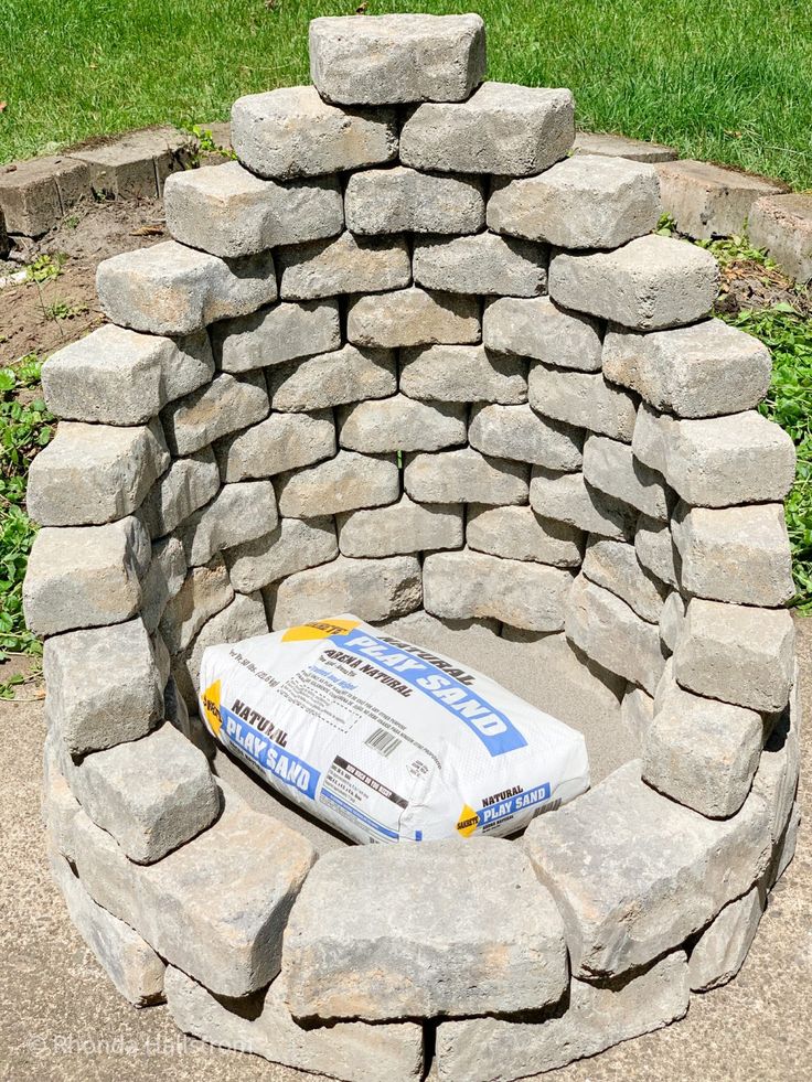 a bottle sitting on top of a pile of rocks in the middle of a circle