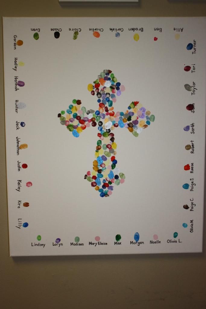 a cross made out of colored circles on a white paper with words written below it