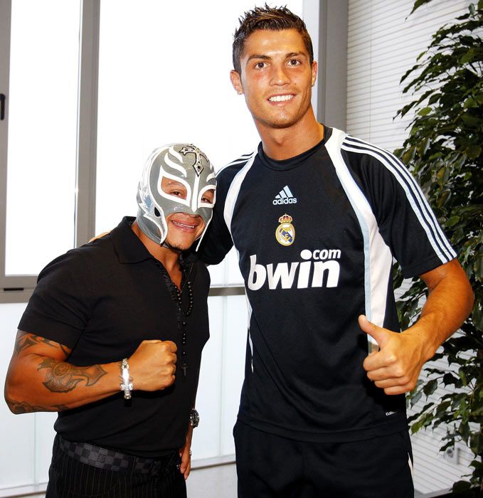 two men wearing masks pose for the camera