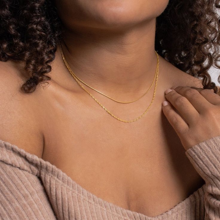 Layering just got easier with the Monet Duo Chain. A dainty snake chain sits atop a sparkling twist chain, otherwise known as a Singapore chain. An effortless and edgy layered look is just one clasp away. Material: High Quality Solid 925 Sterling Silver Finish: Sterling Silver ∙ 18K Gold Featuring a Minimalist Layered Necklace Set with a 14 inch Snake Chain layered with a 15 inch Singapore Chain, length is adjustable up to 2 inches SKU: RR-NR066 Necklaces Minimalist, Initial Tag Necklace, Initial Birthstone Necklace, Minimalist Necklaces, Fingerprint Necklace, Sideways Initial Necklace, Dainty Initial Necklace, Handwriting Necklace, Padlock Necklace