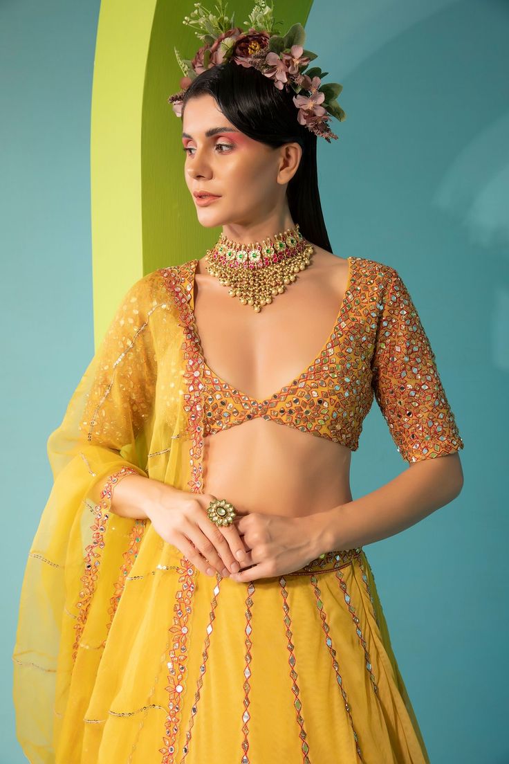 Yellow tulle lehenga with mirror, zari sequin embroidery. Comes with embroidered blouse and dupatta.
Component: 3
Pattern: Embroidered
Type Of Work: Mirror Work
Neckline: Plunged V-Neck
Sleeve Type: Half
Fabric: Tulle, Organza, Lining: Cotton Shantoon
Color: Yellow
Other Details: 
Back cut-out with tie-up
Sheer dupatta with embroidered borders
Occasion: Mehendi and Haldi - Aza Fashions Tulle Lehenga, V Neck Lehenga, Yellow Mirror, Sheer Dupatta, Sequin Embroidery, Sequins Embroidery, Mirror Work, Embroidered Blouse, Set For Women