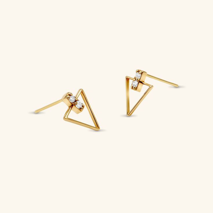 These Diamond Triangle Studs are bound to elevate your earring game to the next level. Mixing geometric shapes with diamonds, sporting these cool studs will be sure to get you the compliments you deserve. - 14k solid yellow gold - Carat weight: 0.16 ctw total - High quality diamonds, G-H color, SI1-SI2 clarity Modern Yellow Gold Earrings With Brilliant Cut, Modern 14k Gold Earrings With Diamond Accents, Modern 14k Gold Diamond Earrings With Single Cut Diamonds, Modern 14k Gold Diamond Earrings With Single Cut, Modern 14k Gold Diamond Earrings, Modern 14k Gold Diamond Earrings For Anniversary, Modern Tarnish Resistant Diamond Earrings For Anniversary, Tarnish Resistant Yellow Gold Diamond Earrings, Modern Tarnish-resistant Diamond Earrings For Anniversary