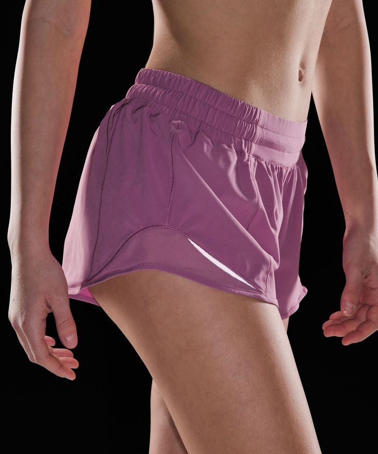 a close up of a person wearing purple shorts