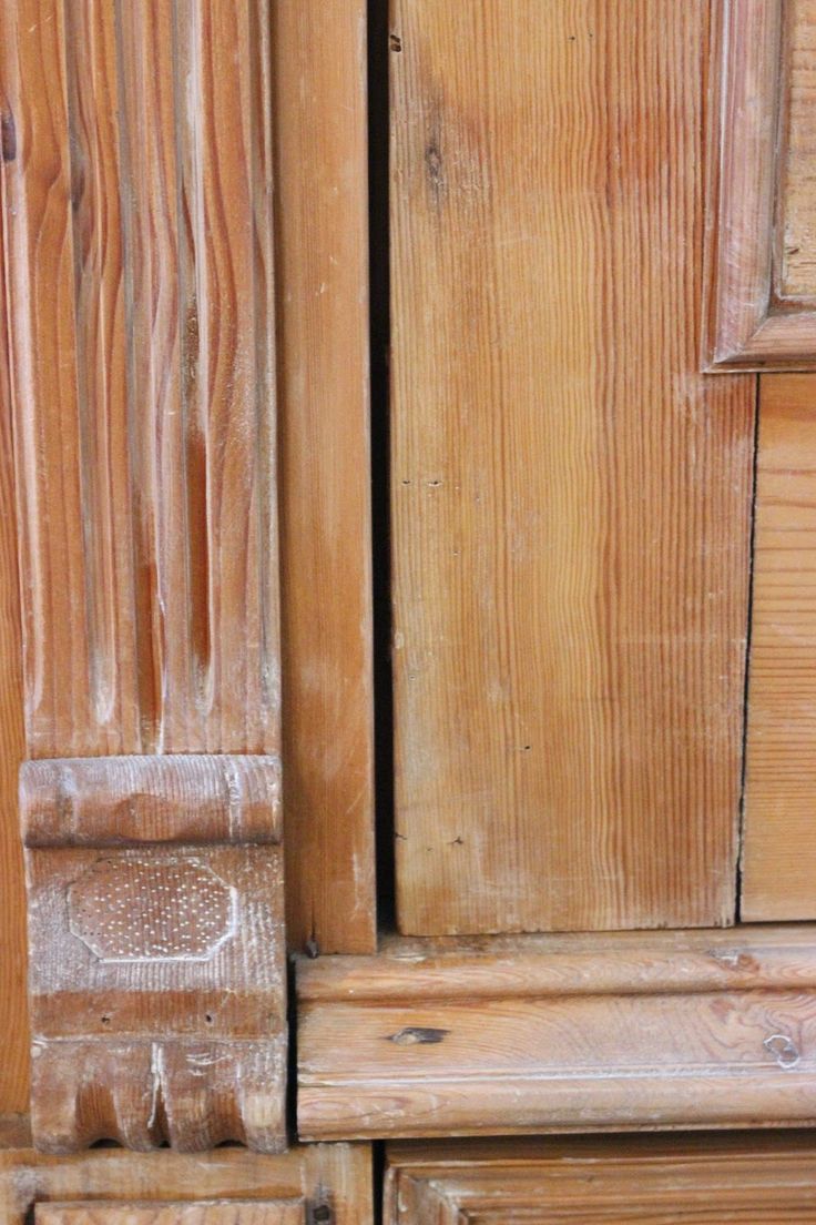 an old wooden cabinet with peeling paint on it