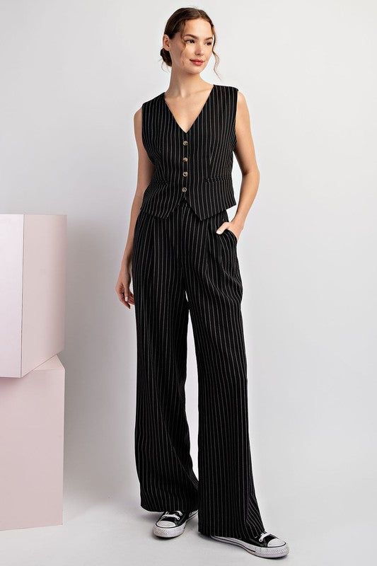 Pinstriped pants featuring a button and zipper closure, belt loops, front pleats for detail, two side hip pockets and is a straight leg design. Styled with our Whitney sleeveless vest. Available in black and navy. Model is 5'9" and is wearing a small. Fit chart in photos Fabric Contents: 92% Polyester, 5% Rayon, 2% Spandex Curvy Girl Dress, Striped Vests, Straight Leg Pant, Pinstripe Pants, Graphic Tops, Leg Design, Suit Vest, Sleeveless Vest, Black Media