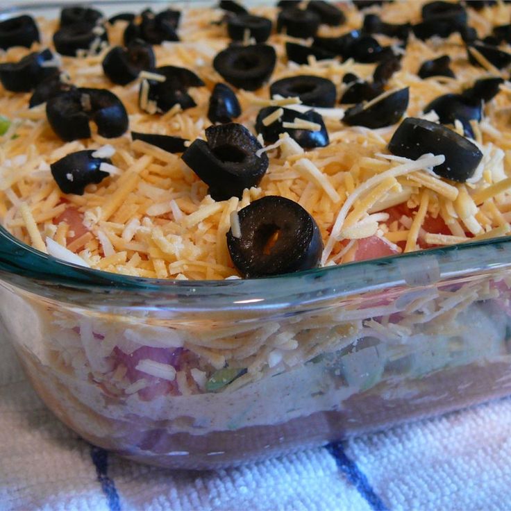 a casserole dish with black olives and cheese