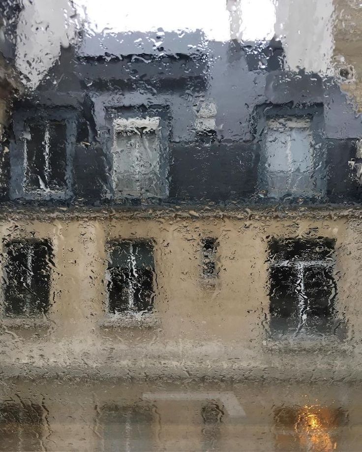 rain is falling on the windows and buildings