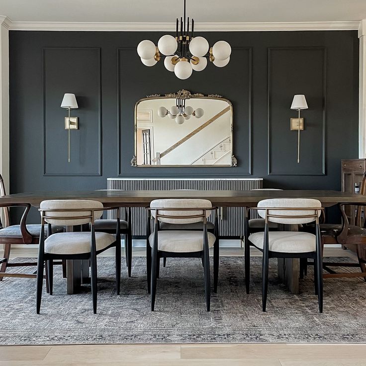 a dining room table with chairs and a mirror on the wall