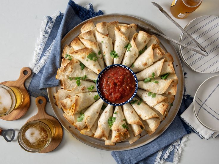 a plate with some food on top of it next to other dishes and utensils