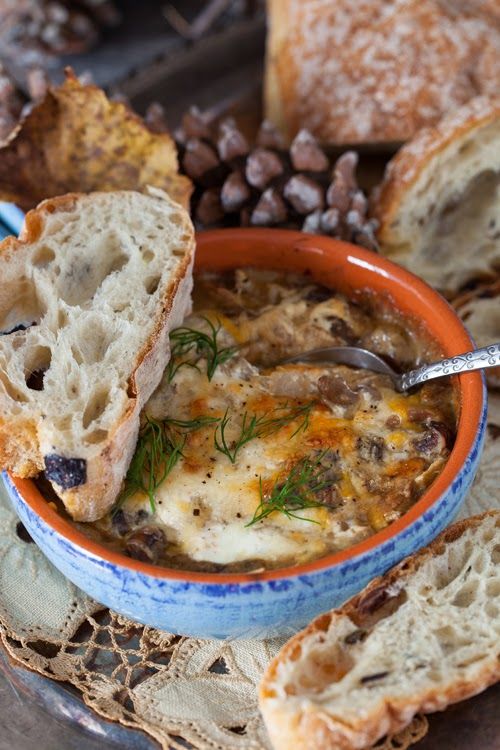 a bowl of soup with bread on the side