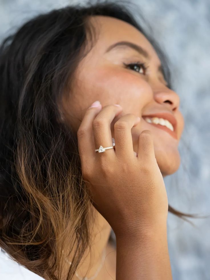 This engagement ring features a 0.70ct trillion cut Borneo diamond. The triangle diamond itself is flanked by five Canadian diamonds on each side. The triangle diamond is set in a split prong basket setting, elevating its sparkle. The diamond is the April birthstone and a hell of a fighter. Wear this ethically sourced diamond ring as your engagement ring, paired with a gold nesting band or a wedding band to create your bridal ring stack. Trillion Cut Diamond Ring With Tension Setting For Promise, Trillion Cut Diamond White Diamond Ring, Trillion Cut Diamond Ring With Prong Setting As Gift, Diamond Trillion Cut Promise Ring, Trillion Cut Single Diamond Ring, White Gold Diamond Ring With Trillion Cut, Trillion Cut Moissanite Diamond Ring Fine Jewelry, Trillion Cut Single Diamond Ring In White Gold, Trillion Cut White Gold Diamond Ring