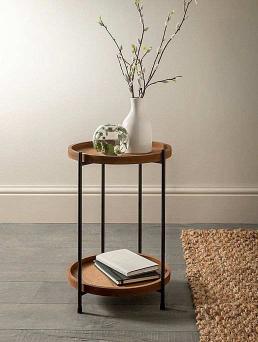 a small table with a vase and some books on it