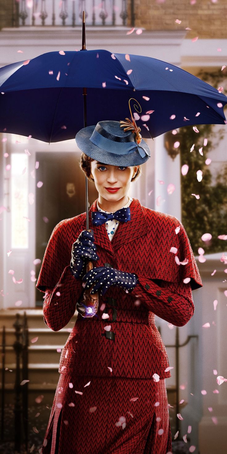 a woman in a red dress and blue hat holds an umbrella over her head as confetti falls around her