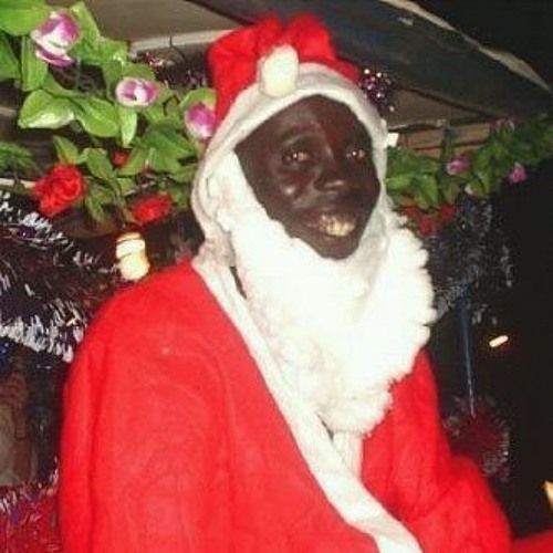 a man dressed up as santa clause in front of christmas decorations