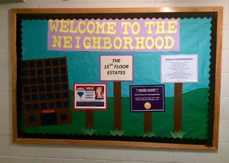 a bulletin board with information about neighborhood and other things on it in a school hallway